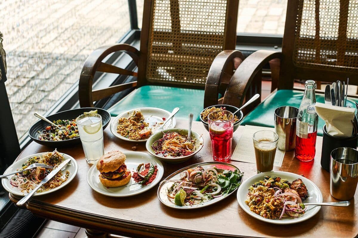 Dishes, drinks and chai laid out across a Dishoom table