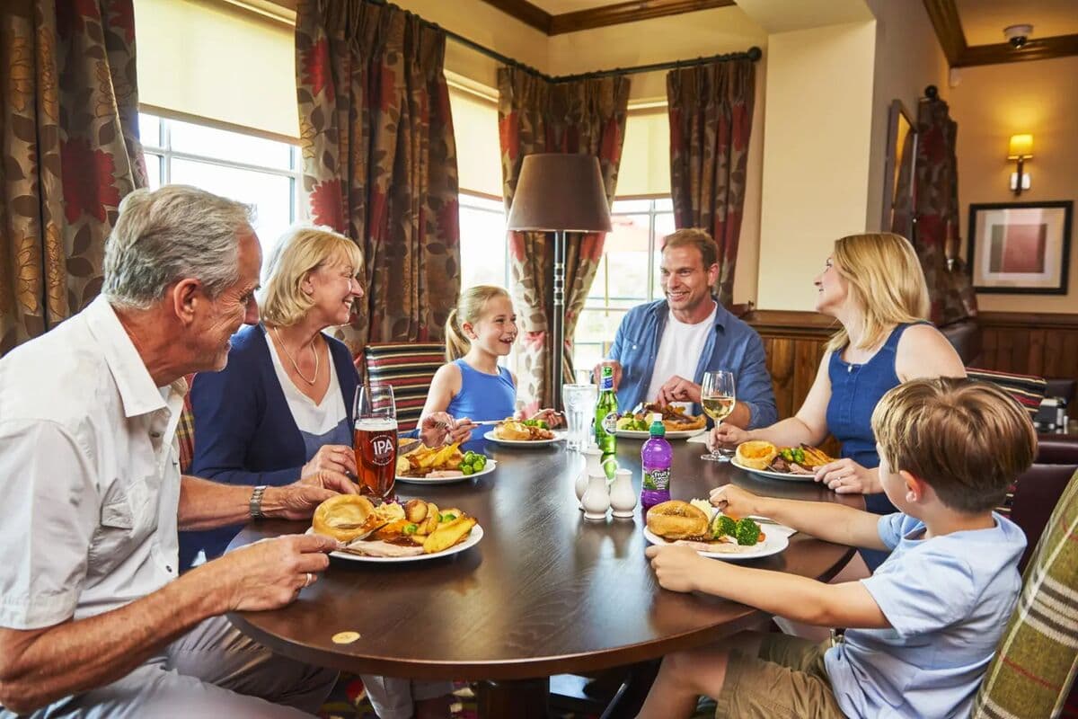 A family sharing a carvery meal at a Farmhouse Inns pub