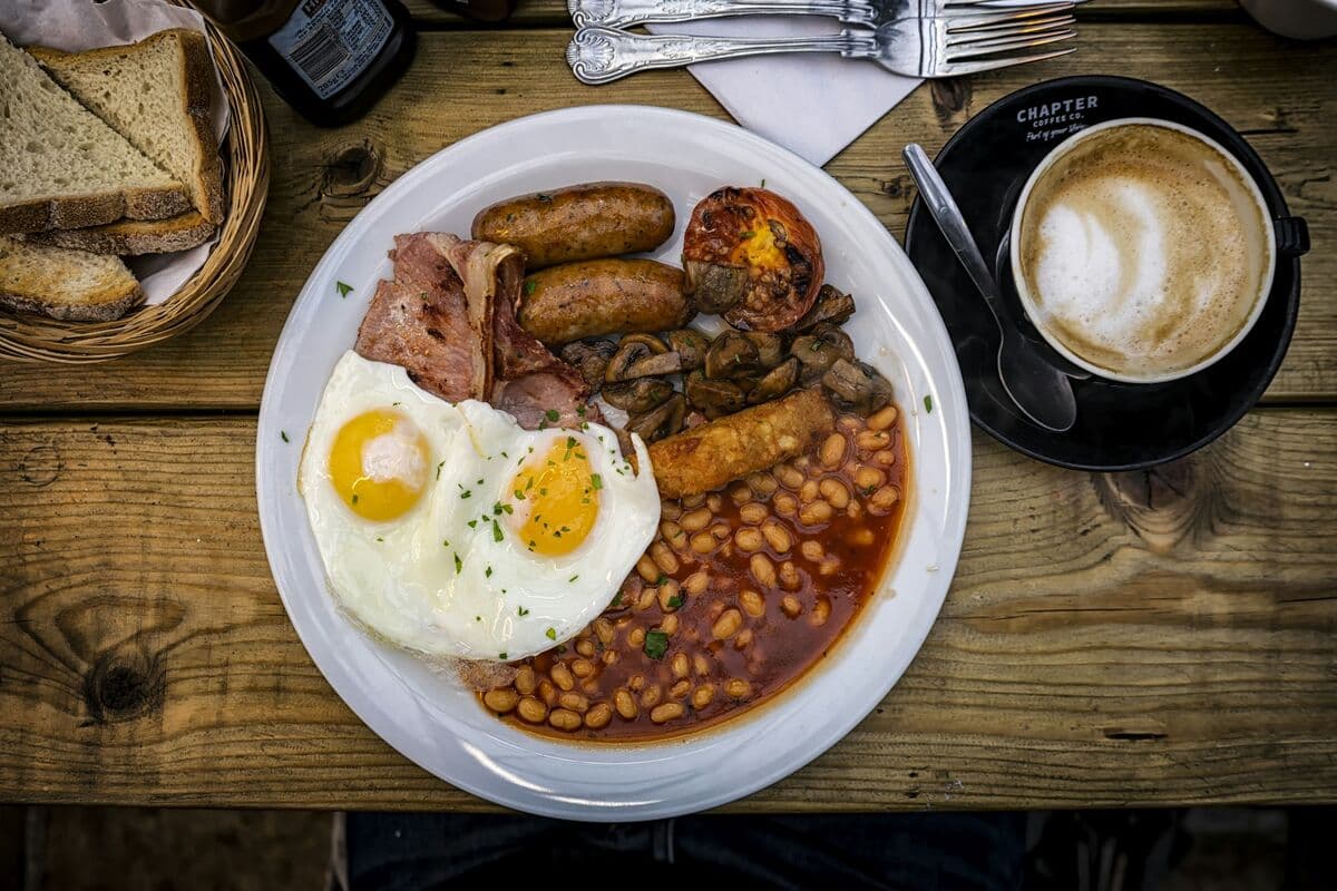 A full fry-up breakfast with a coffee