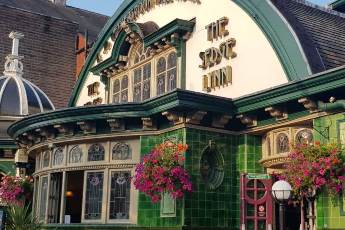 A Wetherspoon pub frontage covered in hanging baskets