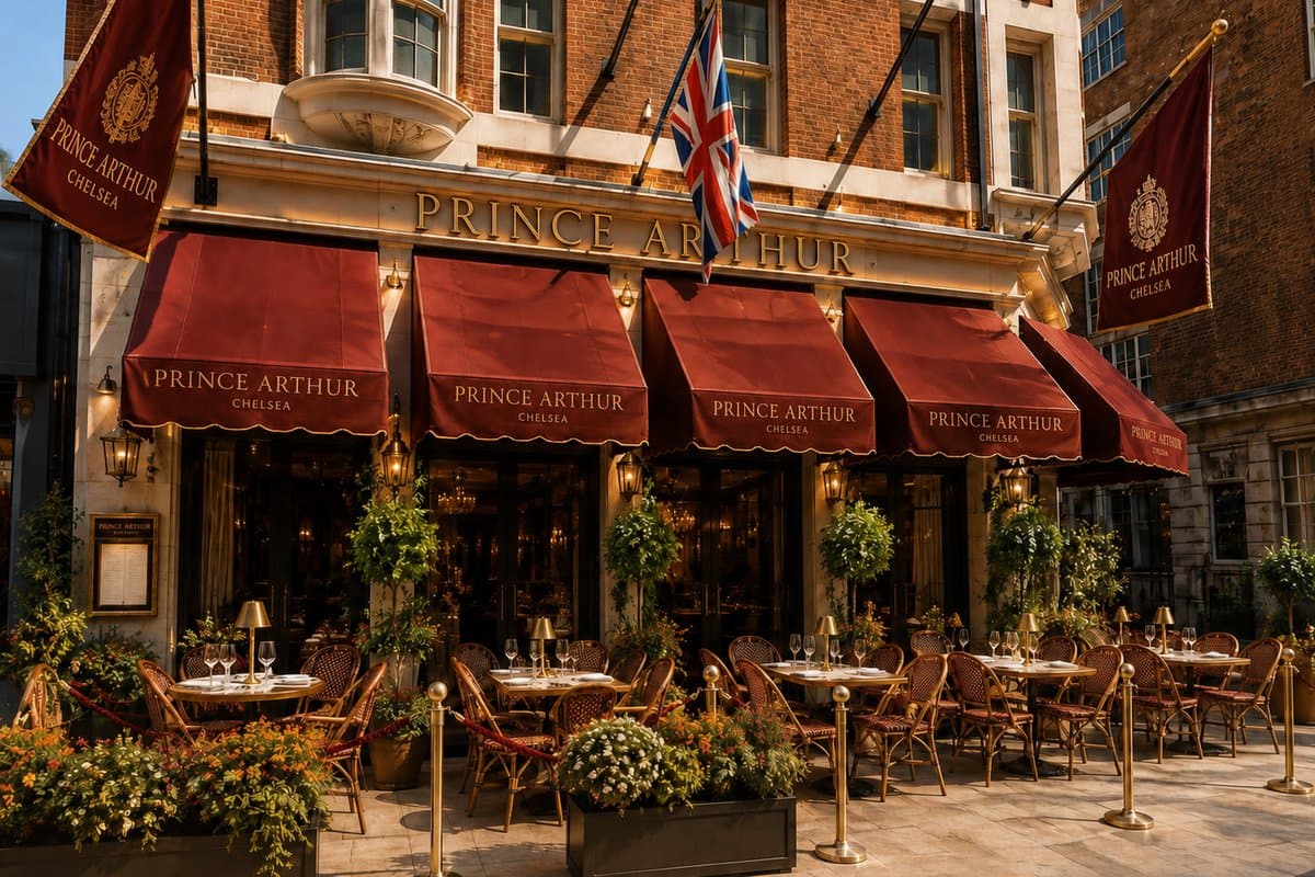 The Prince Arthur Chelsea frontage with red awnings, banners and outdoor tables