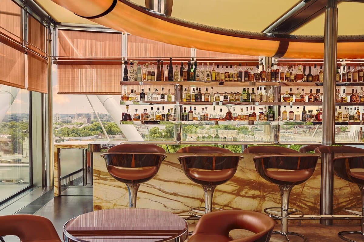 The rooftop bar at The Emory with leather bar stools and views over Hyde Park