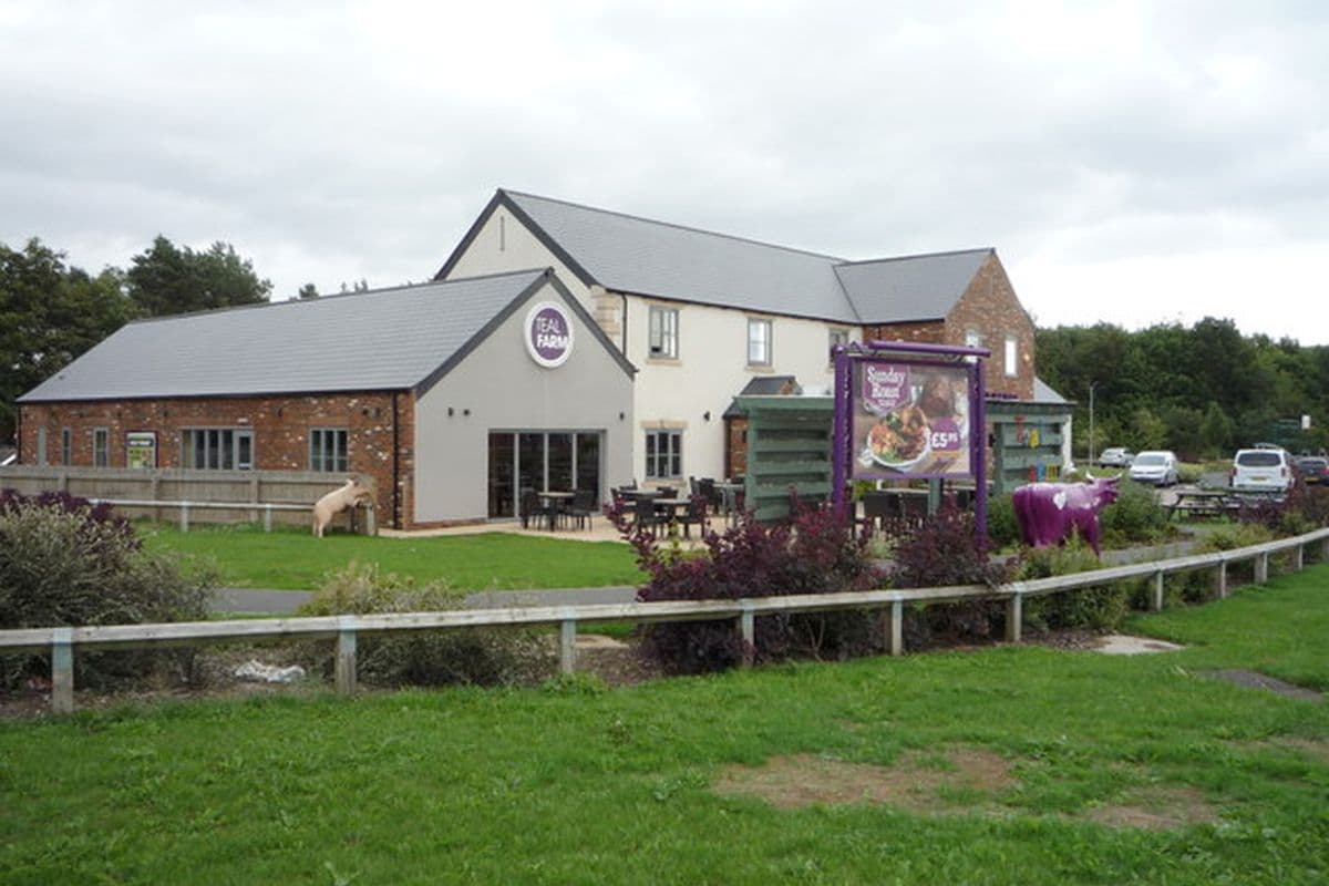 The Teal Farm pub in Washington, a large white and brick building with a grass verge in front