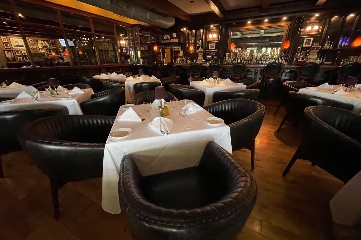 An Italian restaurant dining room with wooden chairs and warm lighting