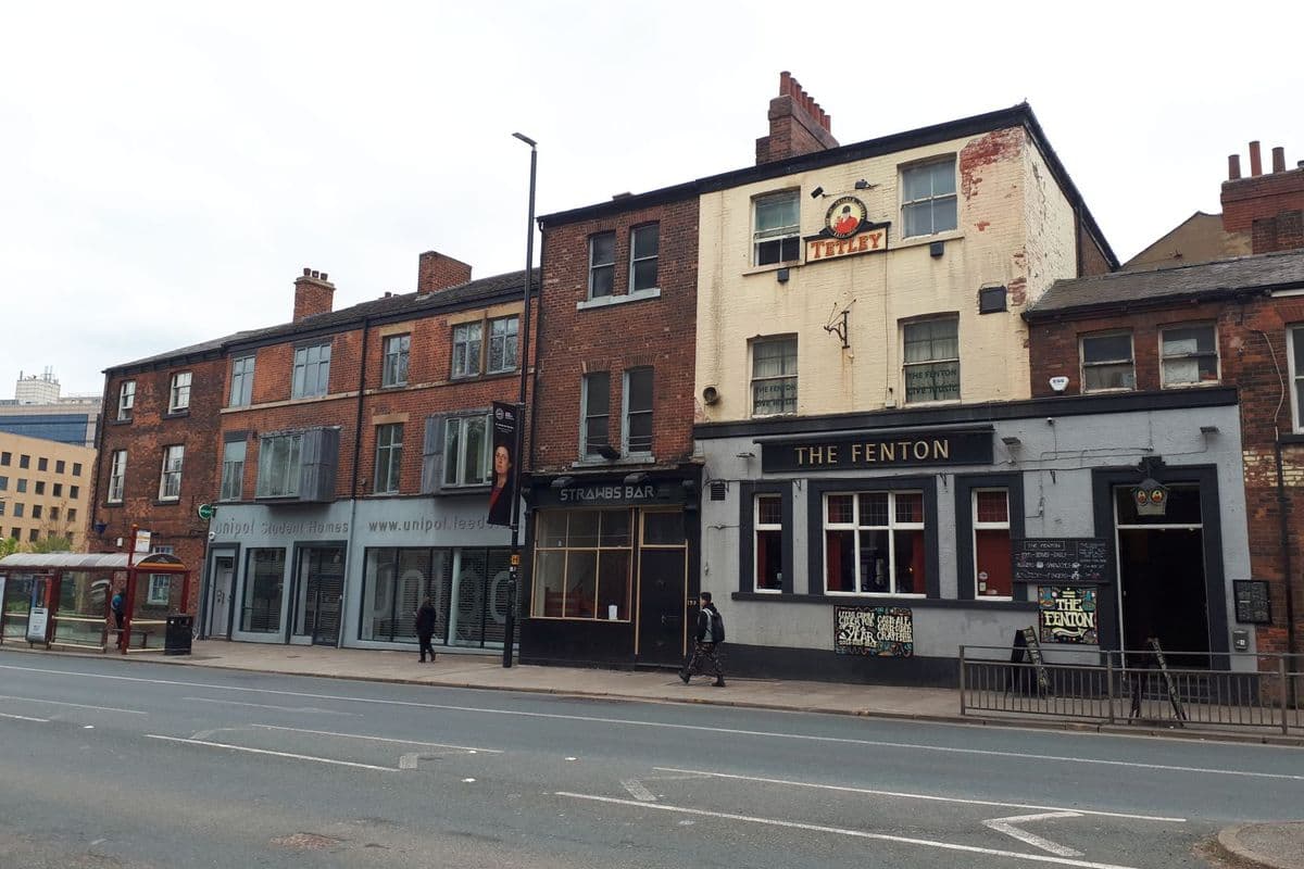 The exterior of a traditional British pub on a street corner