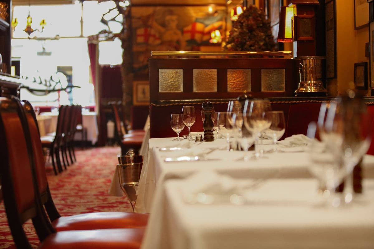 Close-up of white table settings and glassware at Rules restaurant
