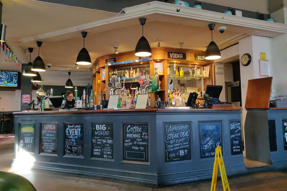The bar of a London pub with beer taps and chalkboard menus