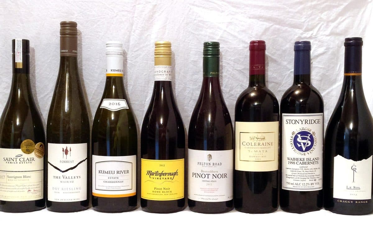 A row of wine bottles lined up on a table