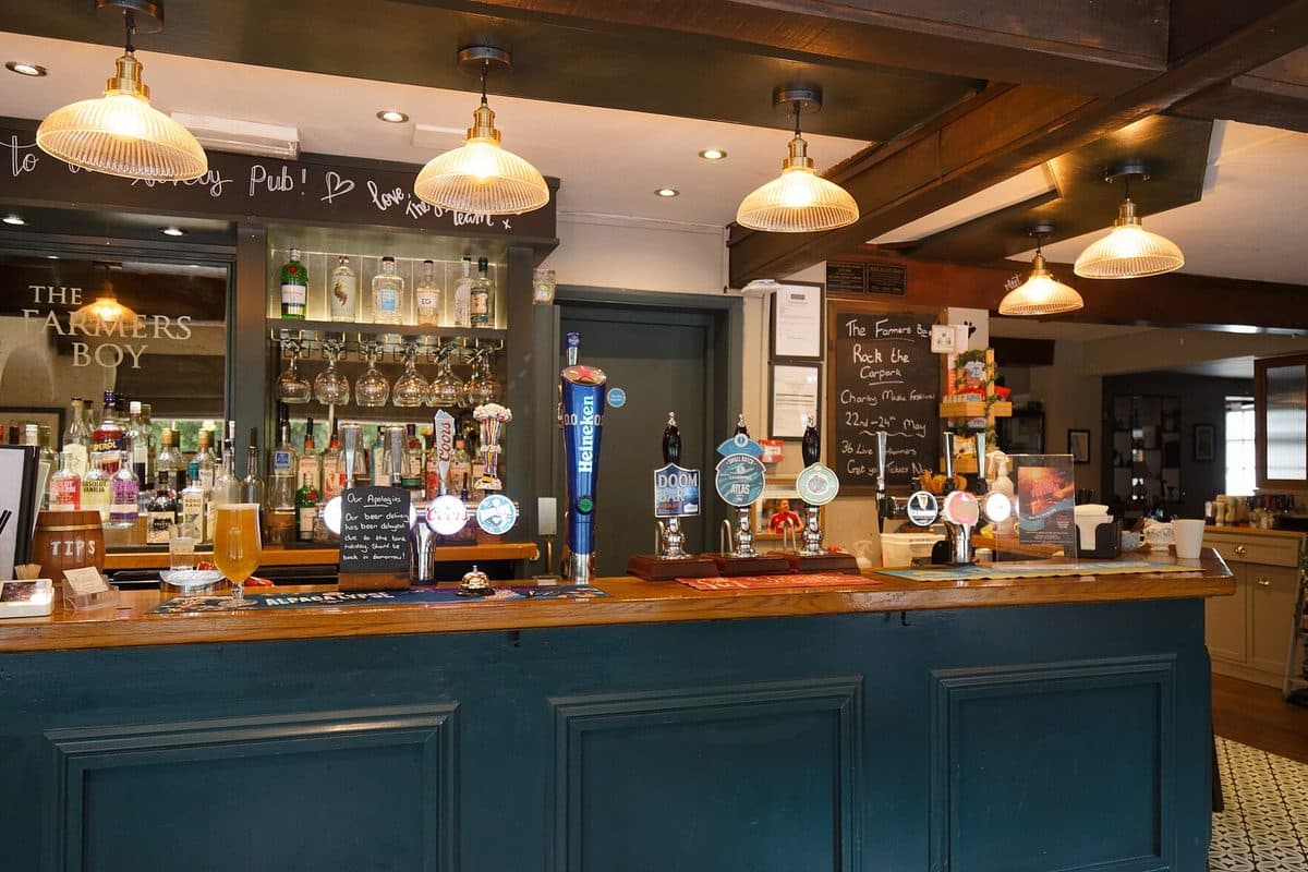 The bar of a country pub in Hertfordshire, with hand pumps and hanging lamps