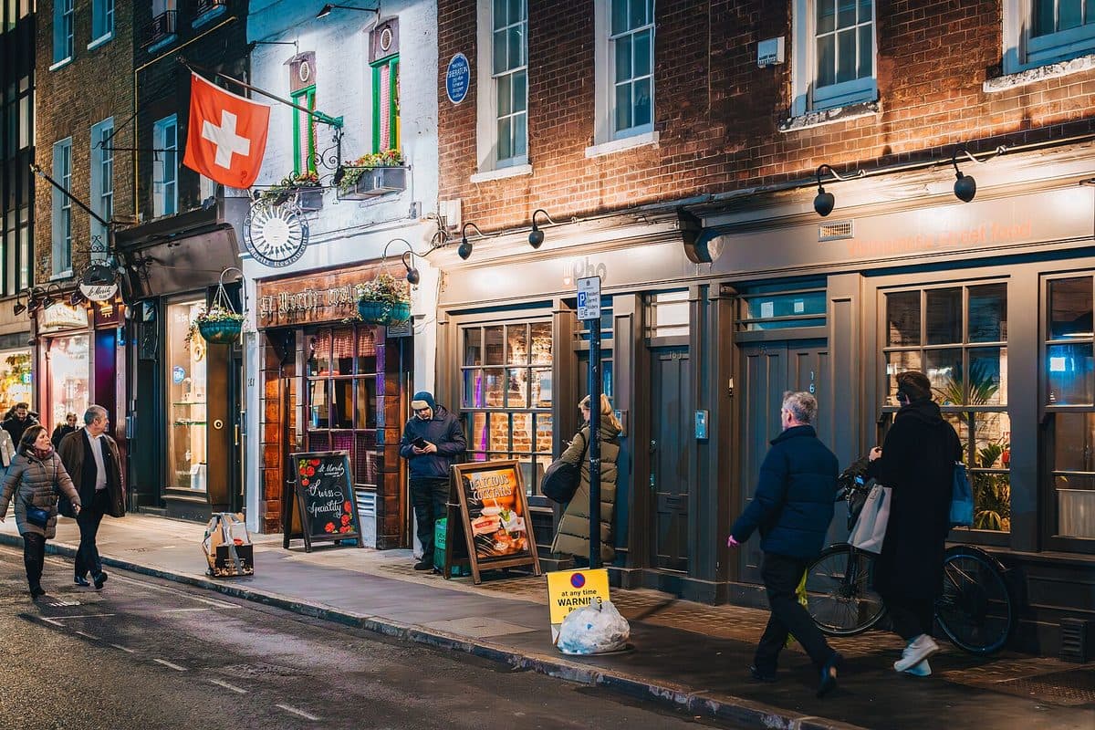 Wardour Street in central London at night, with lit shopfronts