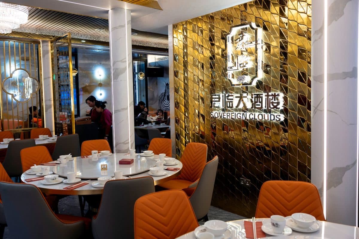 The dining room at Sovereign Clouds with gold walls and orange chairs