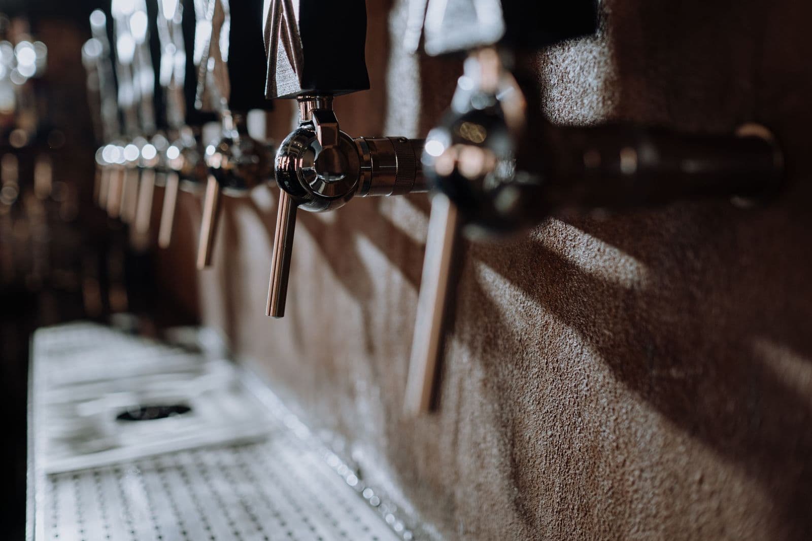 Row of beer taps on a bar