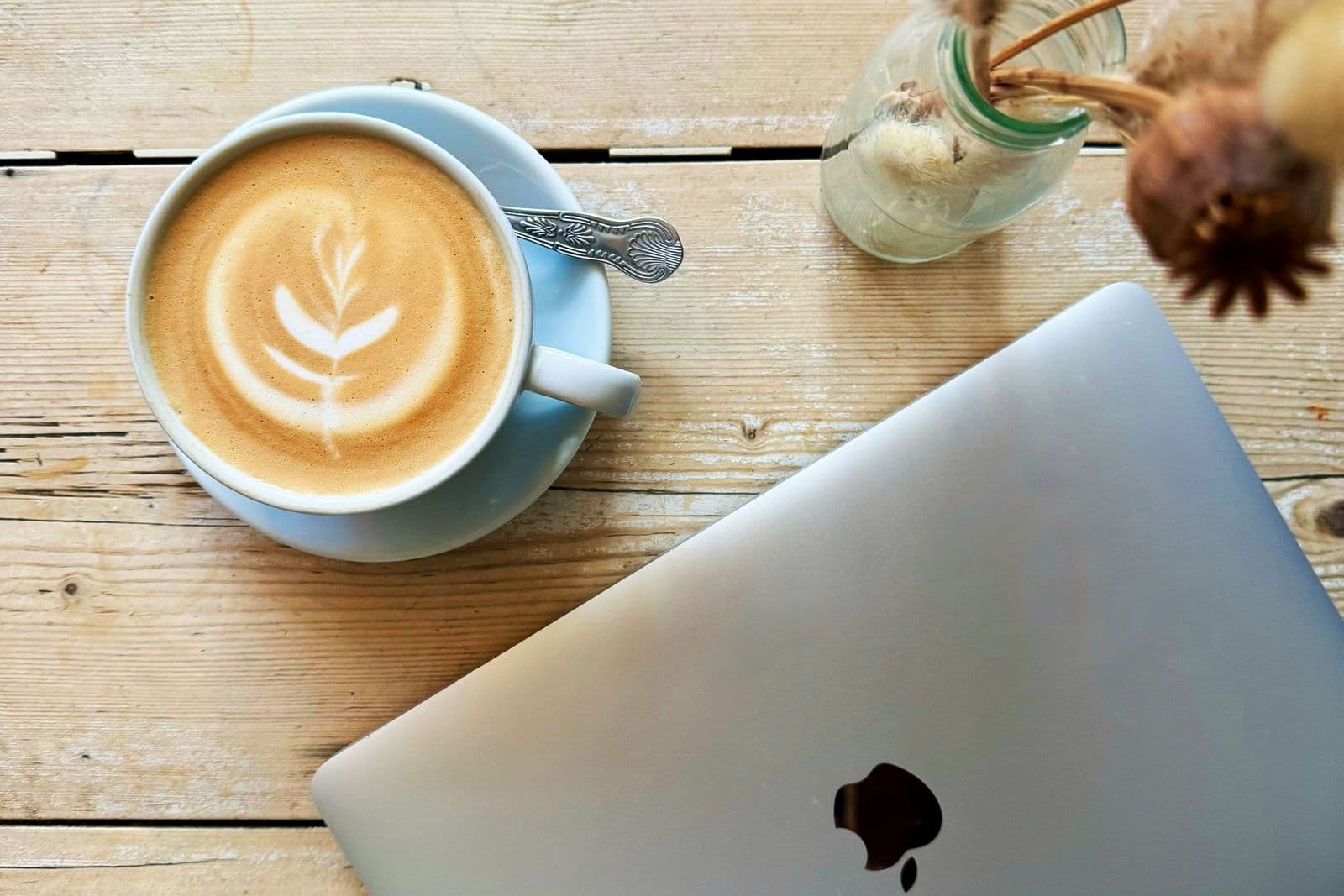 Laptop and latte on a cafe table