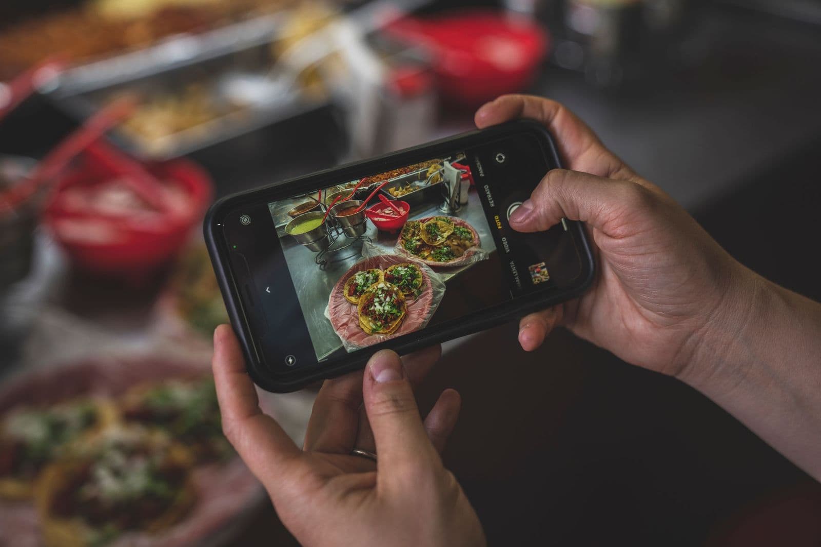 Phone screen framing a plate of tacos