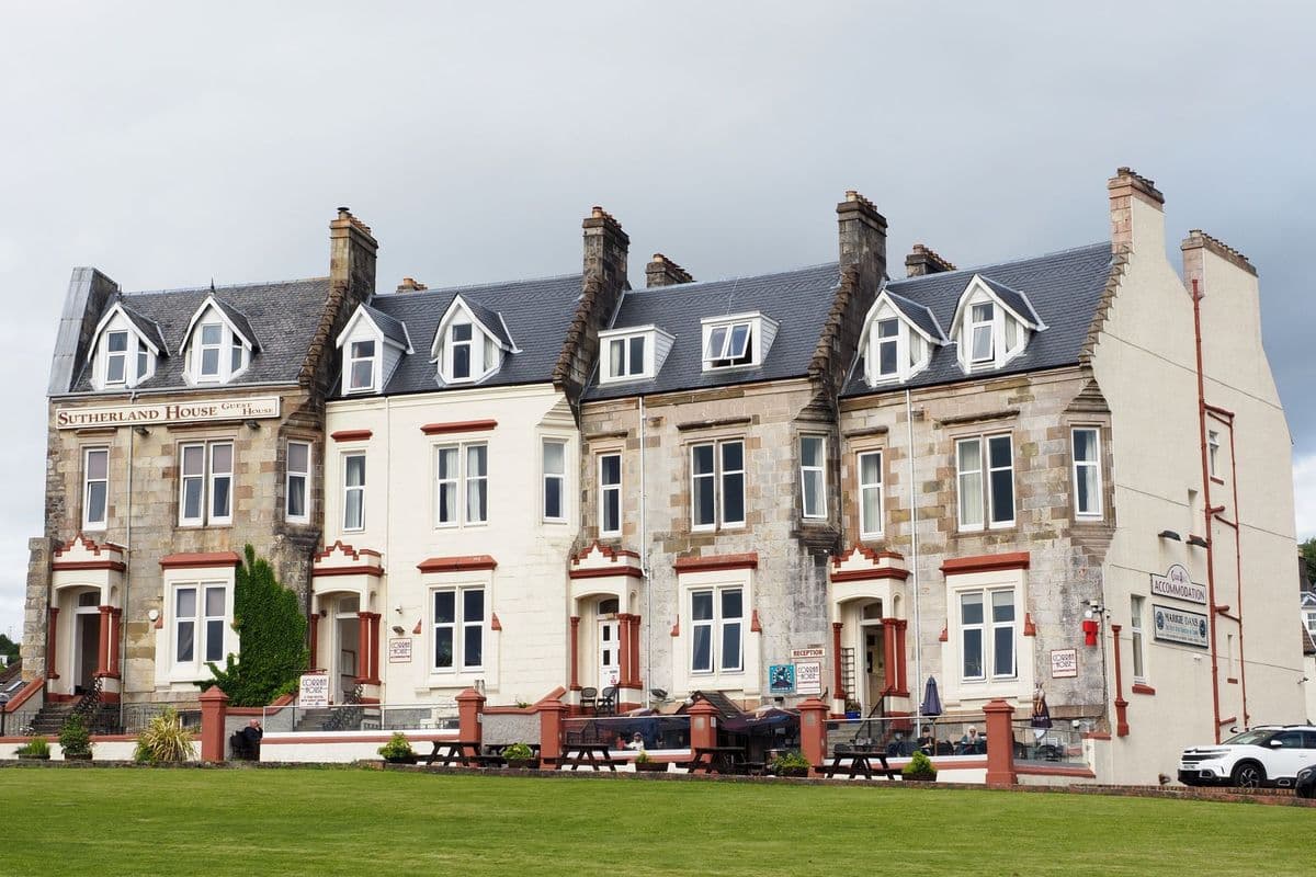 A row of grand historic stone buildings under a blue sky