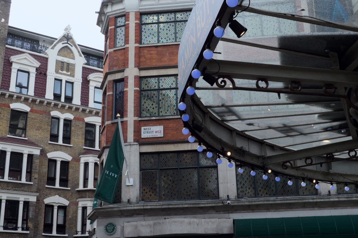 The green awning of The Ivy restaurant on West Street in London