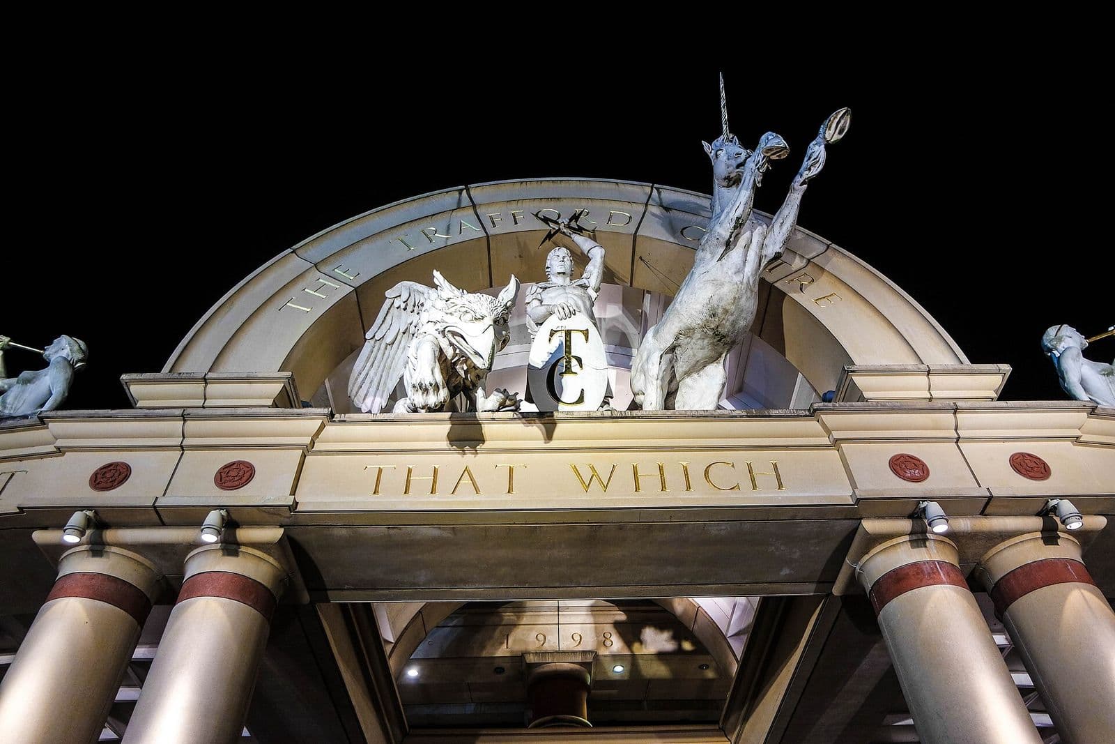 The ornate entrance arch to The Orient at the Trafford Centre, lit up at night