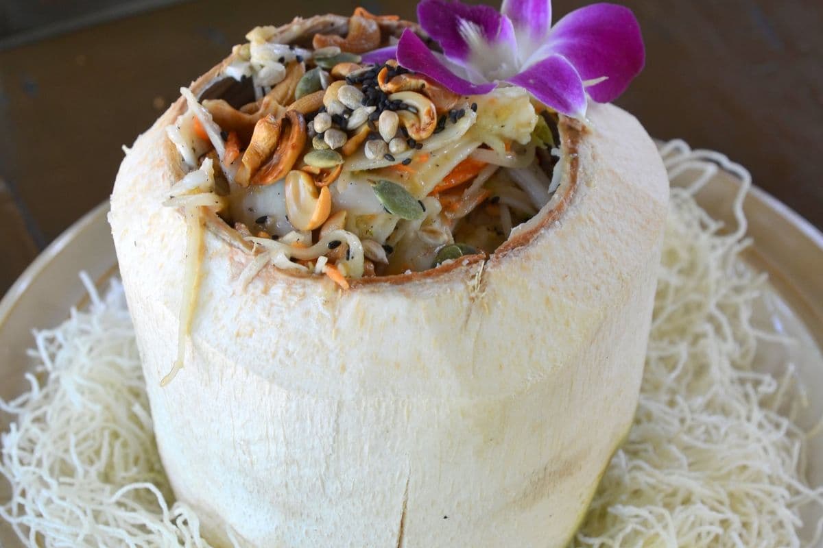 A colourful composed food bowl with fresh vegetables and noodles