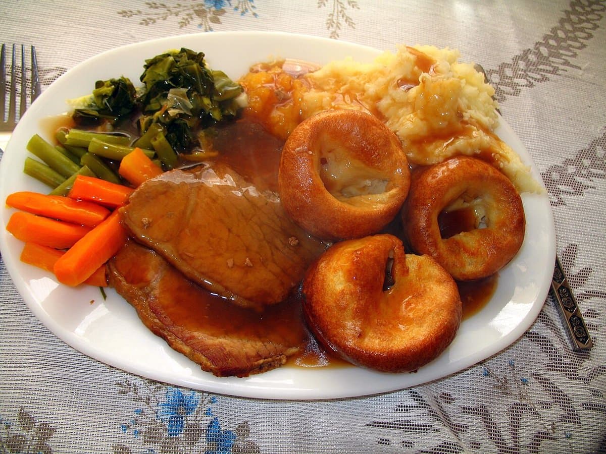 A traditional Sunday roast with Yorkshire pudding and vegetables