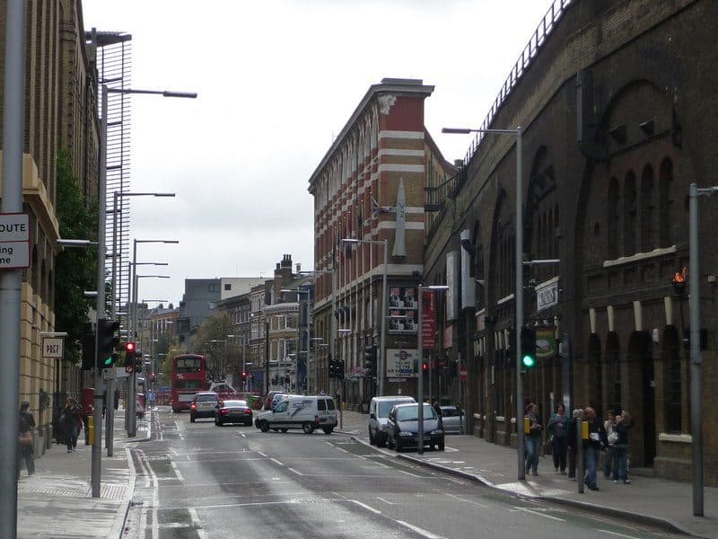 Tooley Street near London Bridge, lined with brick railway arches and offices
