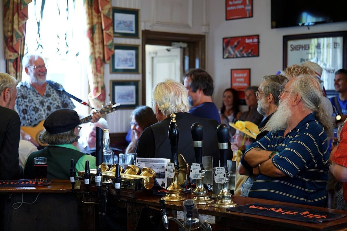 Bar staff serving a busy pub bar in Broadstairs, Kent