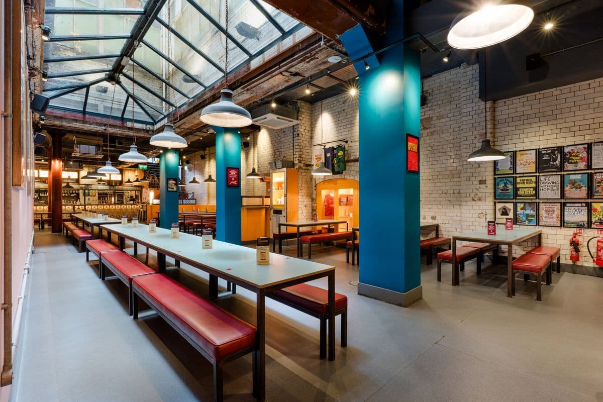 Long tables under the glass atrium at Bundobust Piccadilly
