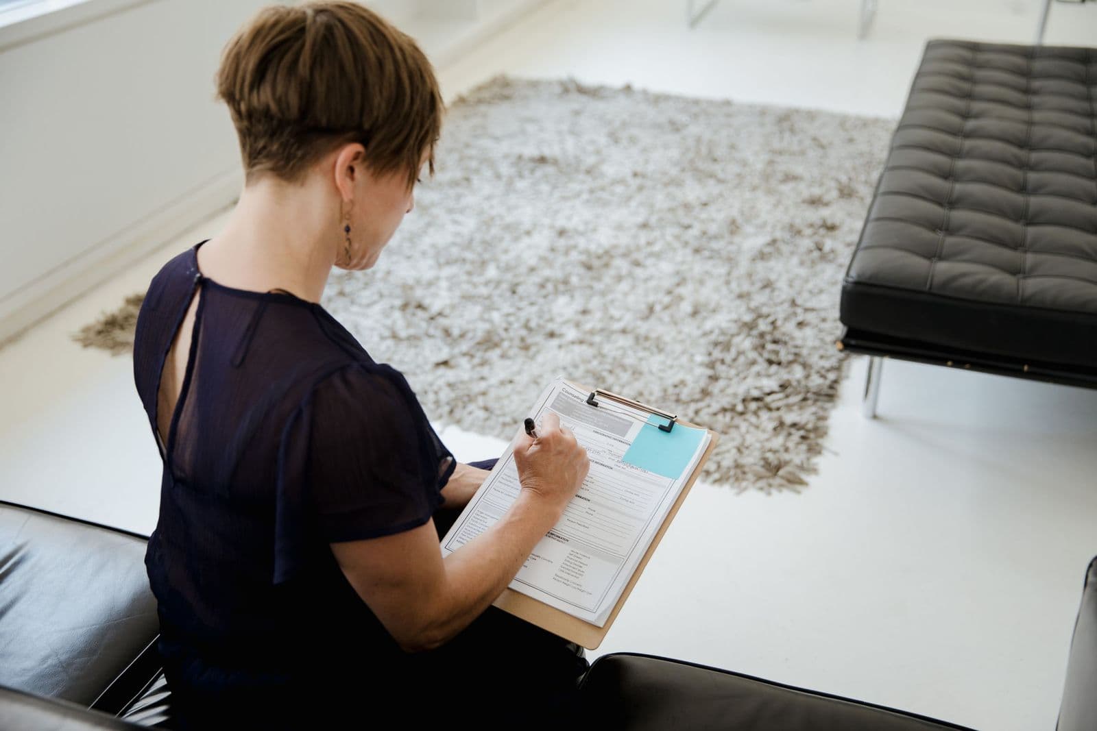 Person writing on a clipboard