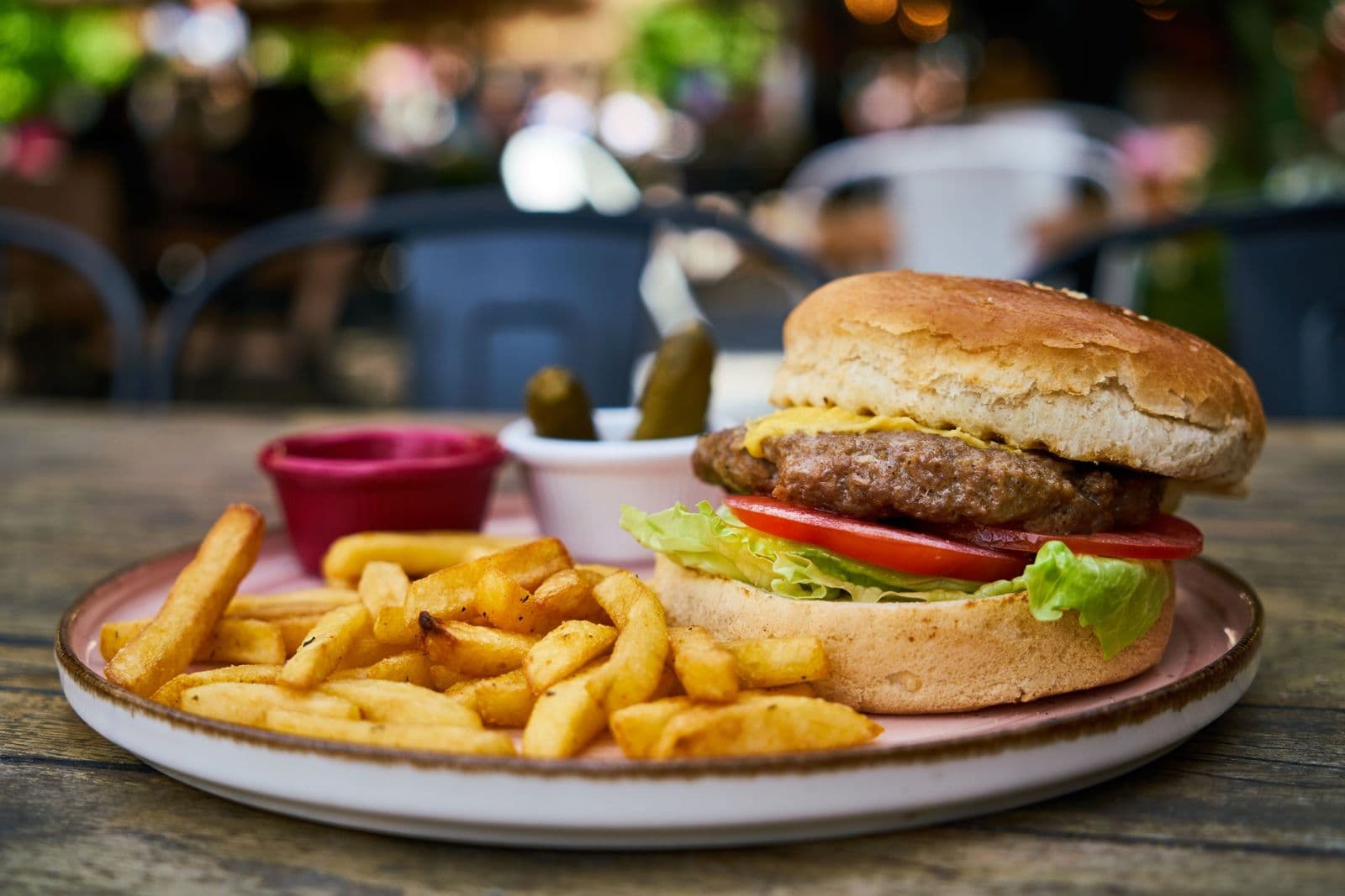Cheeseburger and fries on a white plate