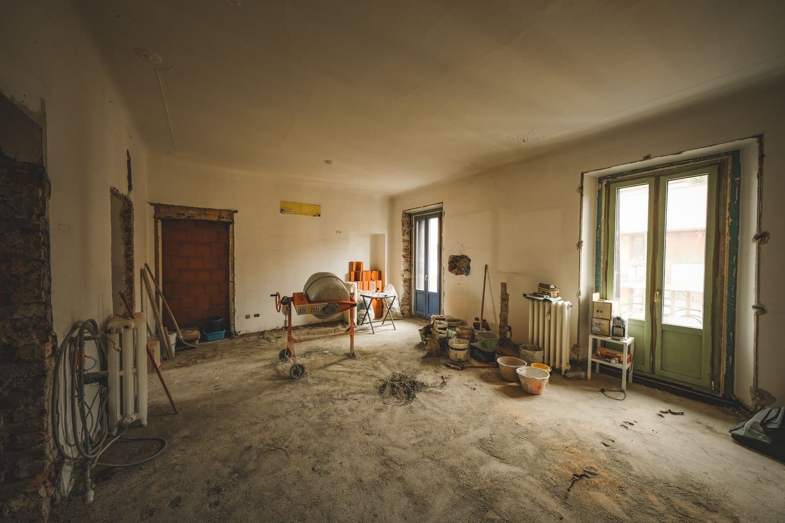 A sunny room under renovation with building materials and tools